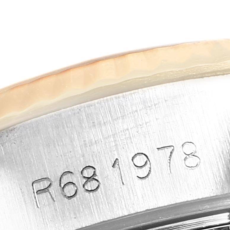 The image shows a close-up of the case side and bezel of a Rolex Datejust 69173 Women's Stainless Steel Champagne Dial 69173 Women's Stainless Steel Champagne Dial, displaying a part of the engraved serial number.