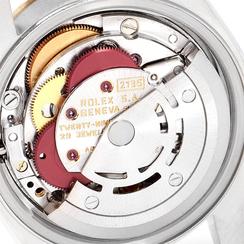 The image shows a close-up of the movement inside a Rolex Datejust 69173 Women's Stainless Steel Champagne Dial 69173 Women's Stainless Steel Champagne Dial watch, highlighting its gears and intricate components.