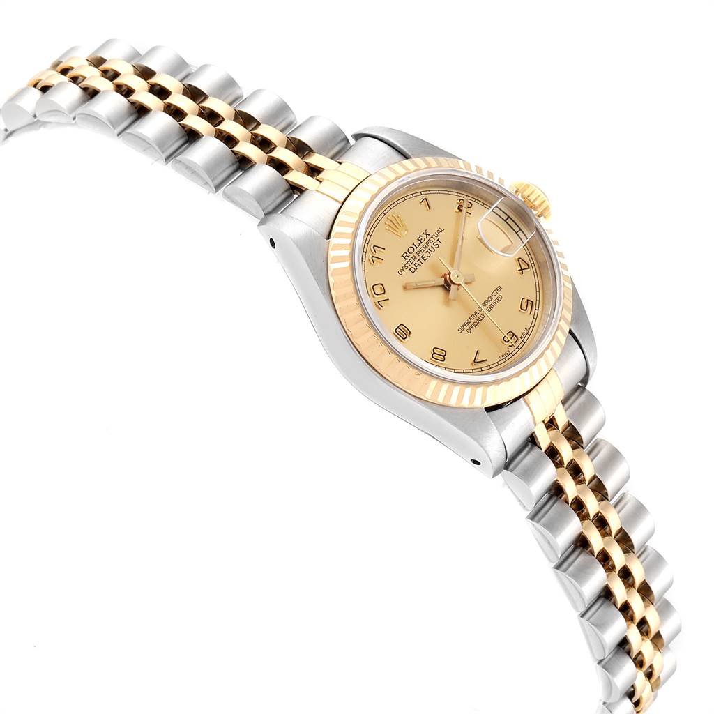 The Rolex Datejust 69173 Women's Stainless Steel Champagne Dial 69173 Women's Stainless Steel Champagne Dial watch is shown at an angle highlighting its gold and silver bracelet and champagne-colored face with a date display.