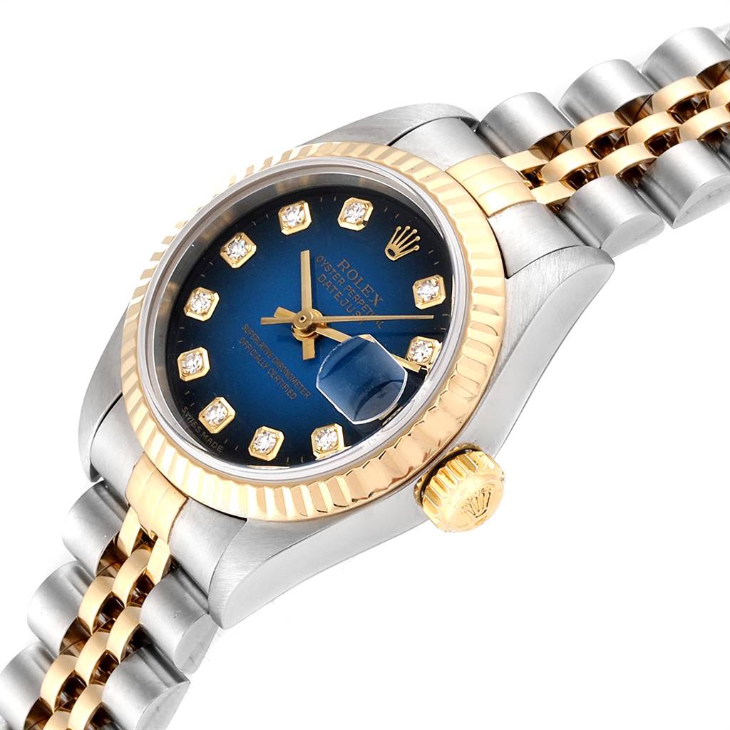 The image shows a Rolex Datejust 79173 Women
s Steel and Gold (two tone) Blue Dial 79173 Women
s Steel and Gold (two tone) Blue Dial watch at an angle highlighting the dial, bezel, crown, and bracelet.
