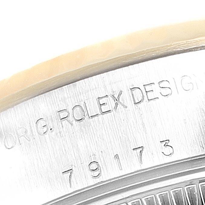 This image shows a close-up of the engraved case back of a Rolex Datejust 79173 Women
s Steel and Gold (two tone) Blue Dial 79173 Women
s Steel and Gold (two tone) Blue Dial watch, highlighting the serial and model numbers.
