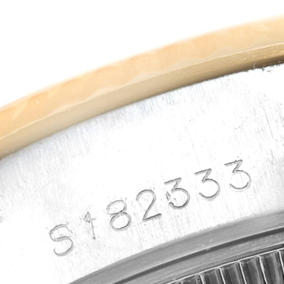 This close-up image of the Rolex Datejust 69173 Women's Stainless Steel Champagne Dial 69173 Women's Stainless Steel Champagne Dial model shows the engraved serial number on the watch's case.