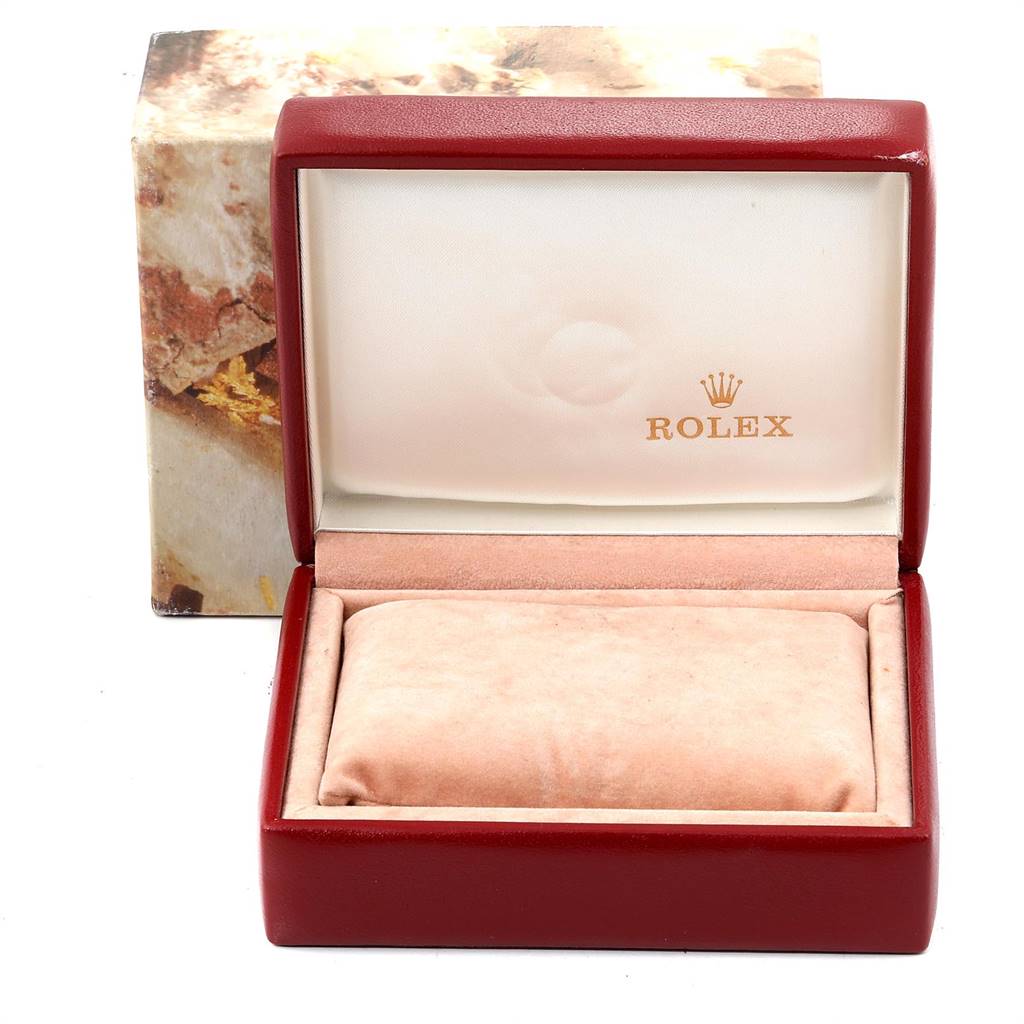 This image shows an open Rolex watch box for a Datejust model, featuring branding inside the lid.