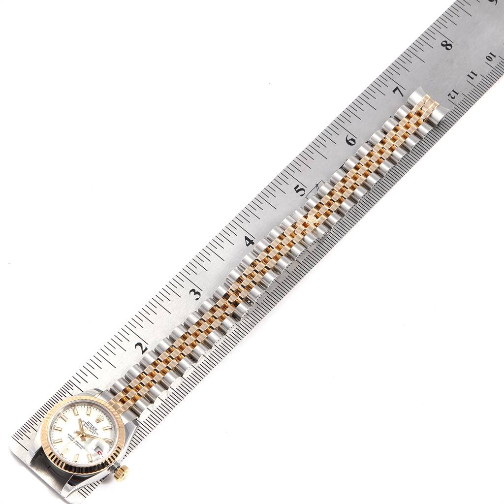 A Rolex Datejust 179173 Women's Steel and Gold (two tone) White Dial 179173 Women's Steel and Gold (two tone) White Dial watch is shown flat with its bracelet stretched out, measured against a ruler.