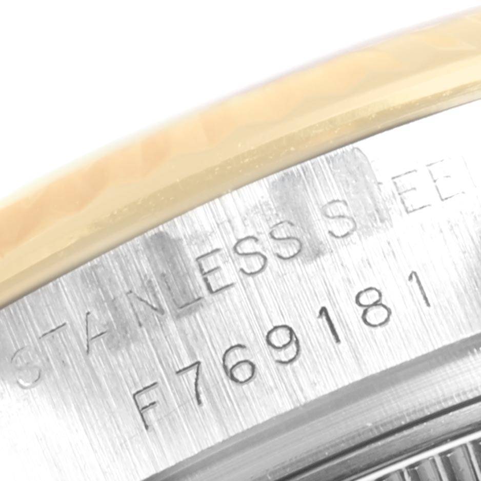 The image shows a close-up of the side of the Rolex Datejust 179173 Women's Steel and Gold (two tone) White Dial 179173 Women's Steel and Gold (two tone) White Dial watch, highlighting the serial number and "STAINLESS STEEL" engraving.