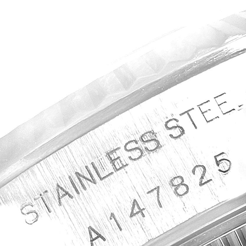 The image shows a close-up of the case side with the engraving "STAINLESS STEEL" and the serial number of the Rolex Datejust 69174 Women's Stainless Steel Black Dial 69174 Women's Stainless Steel Black Dial watch.