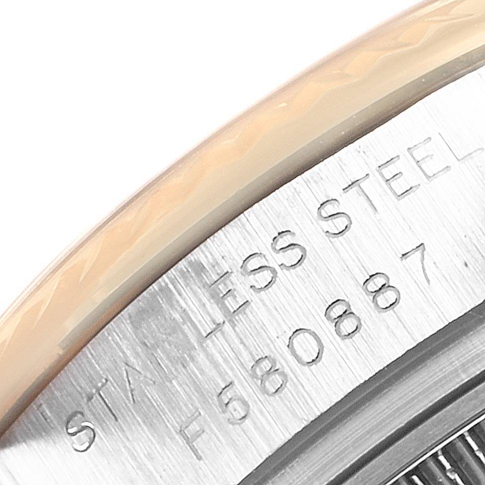 The image shows a close-up of the stainless steel case of a Rolex Datejust 179173 Women
s Steel and Gold (two tone) Black Dial 179173 Women
s Steel and Gold (two tone) Black Dial, highlighting part of the serial number.