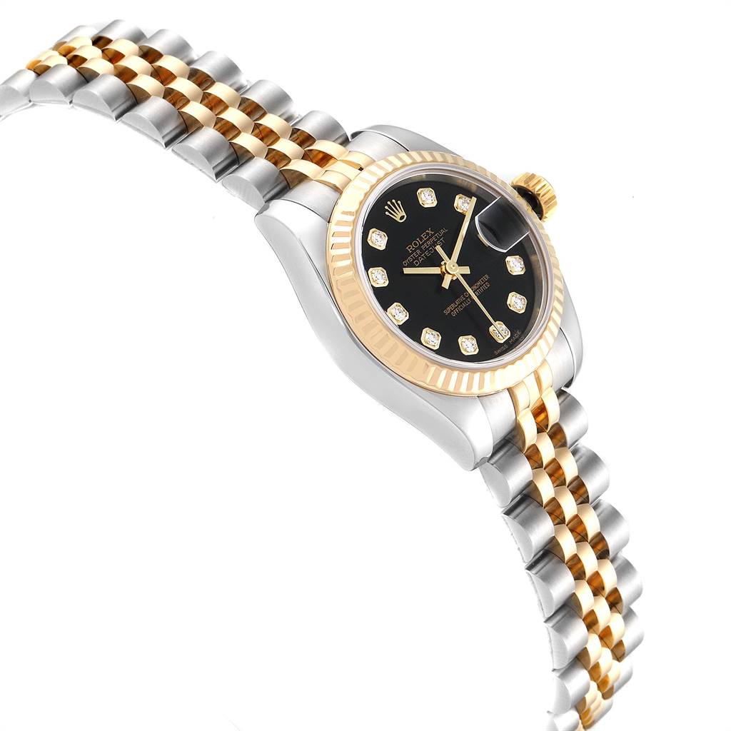 This image shows a side angle of a Rolex Datejust 179173 Women
s Steel and Gold (two tone) Black Dial 179173 Women
s Steel and Gold (two tone) Black Dial watch, highlighting its two-tone metal strap, black dial with diamond markers, and fluted bezel.