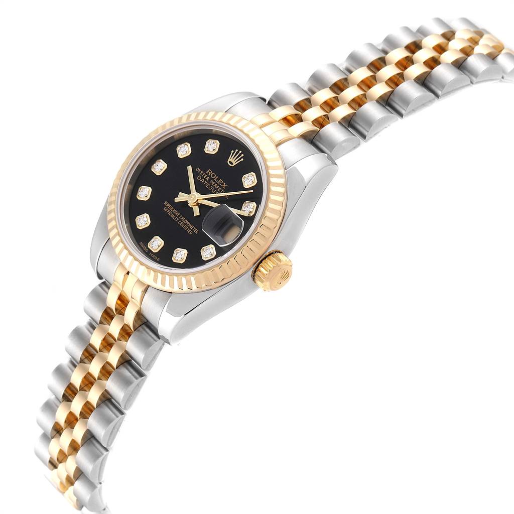 The image shows a Rolex Datejust 179173 Women
s Steel and Gold (two tone) Black Dial 179173 Women
s Steel and Gold (two tone) Black Dial model at an angle, highlighting its face, bezel, and two-tone Jubilee bracelet.
