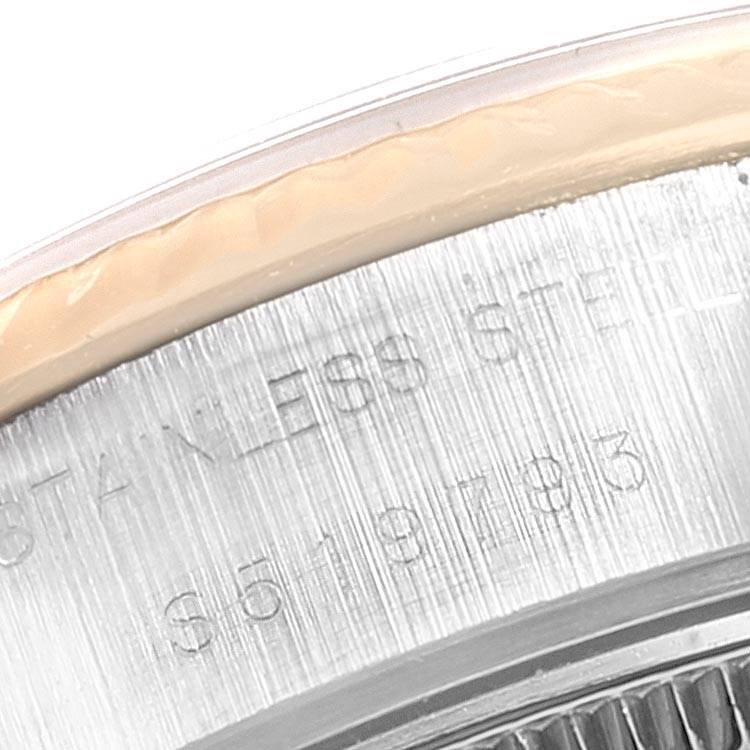 The image shows a close-up of the case back of a Rolex Datejust 69173 Women's Stainless Steel Champagne Dial 69173 Women's Stainless Steel Champagne Dial, highlighting engravings and part of the fluted bezel.