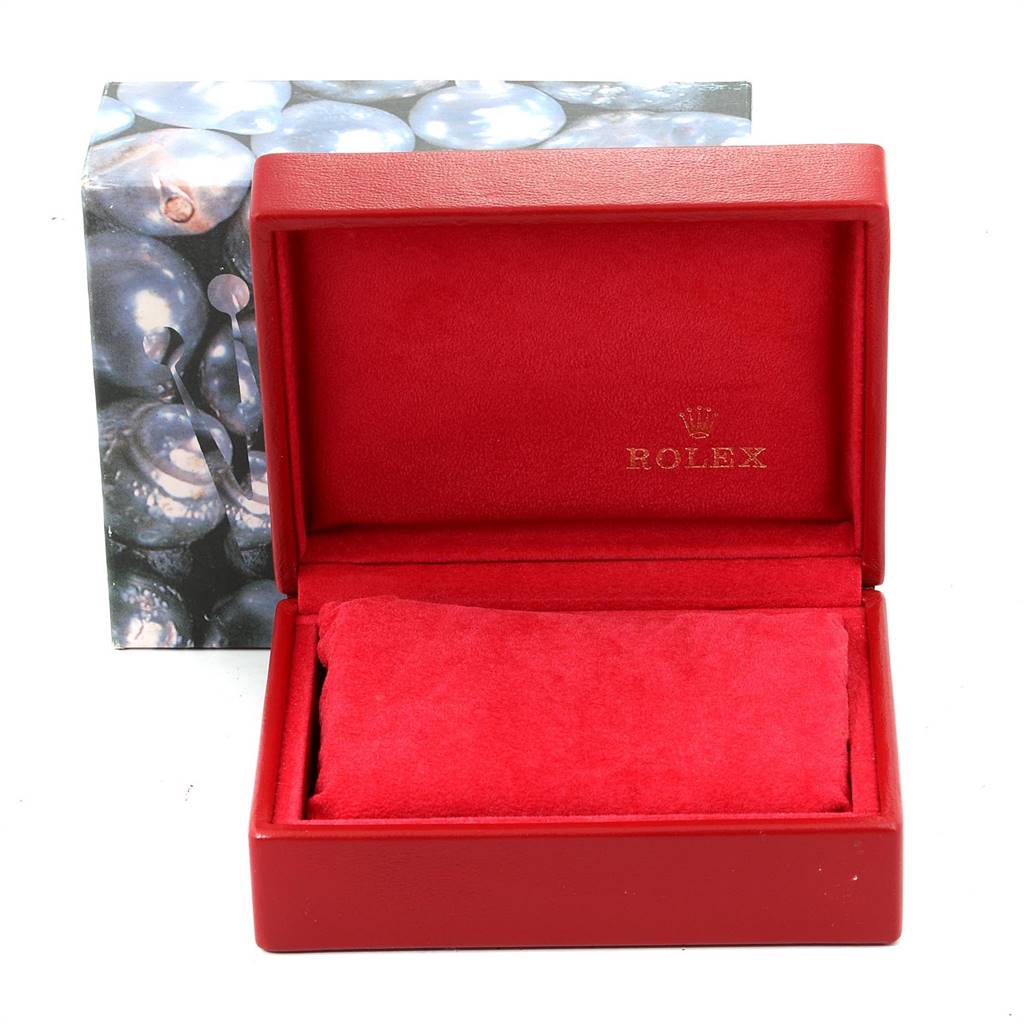 The image shows an open red Rolex box, likely used for housing a Datejust model watch, with a cushion inside.
