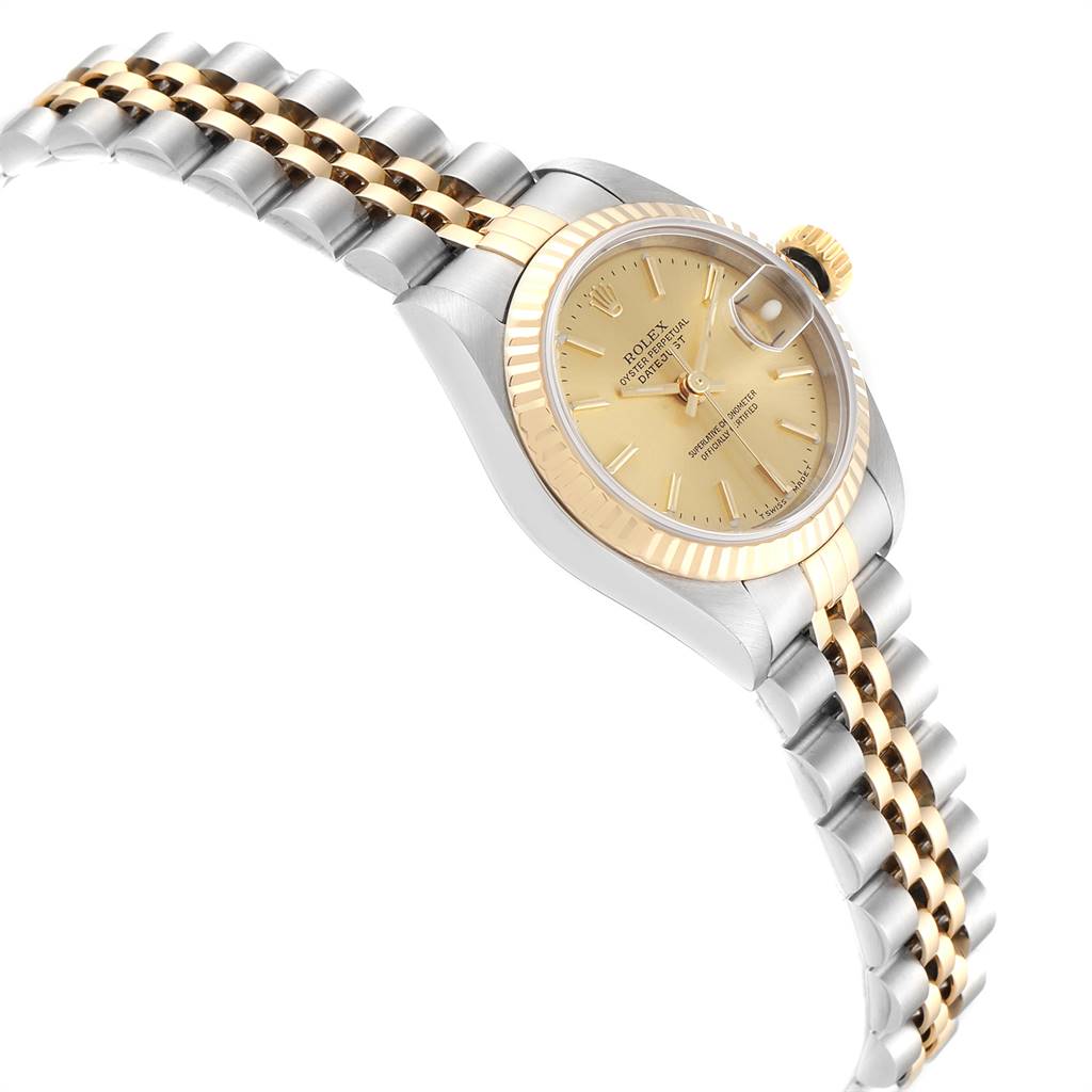 This image shows a Rolex Datejust 79173 Women
s Steel and Gold (two tone) Champagne Dial 79173 Women
s Steel and Gold (two tone) Champagne Dial watch angled to display its dial, crown, fluted bezel, and two-tone jubilee bracelet.