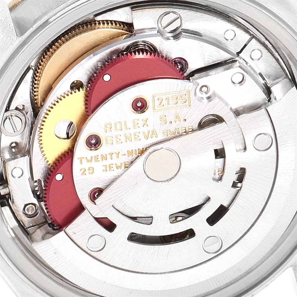 This is a close-up of the movement mechanism in a Rolex Datejust 69173 Women
s Stainless Steel Black Dial 69173 Women
s Stainless Steel Black Dial watch, showing gears and engravings.
