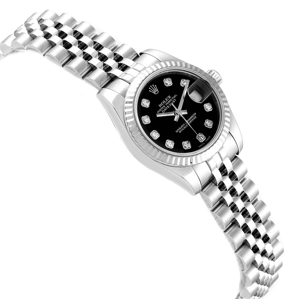 The image shows a Datejust model Rolex watch, angled to showcase its black dial, bracelet, and fluted bezel.