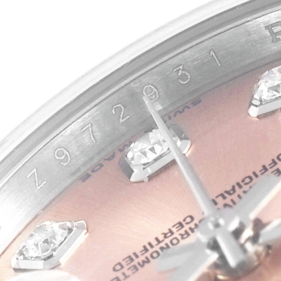 This close-up image of the Rolex Datejust 179174 Women's Stainless Steel Pink Dial 179174 Women's Stainless Steel Pink Dial shows the dial with diamond markers and part of the serial number near the edge.