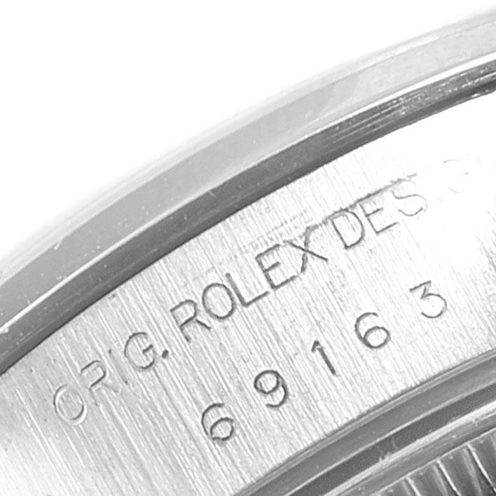 The image shows a close-up angle of the case side, highlighting the "ORIG. ROLEX DESIGN 69163" engraving on the Rolex Datejust 69163 Women
s Stainless Steel Blue Dial 69163 Women
s Stainless Steel Blue Dial model.