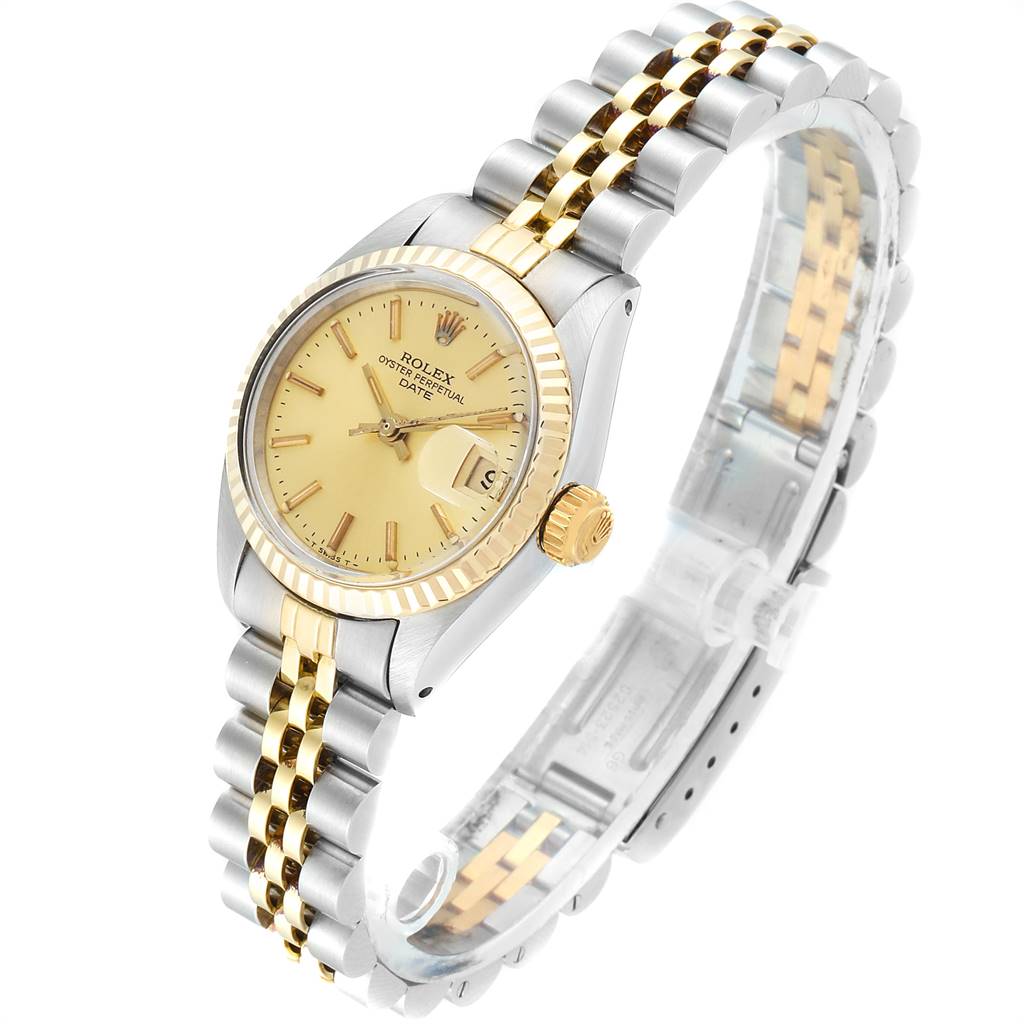 The image shows a side angle of the Rolex Datejust 6917 Women's Steel and Gold (two tone) Champagne Dial 6917 Women's Steel and Gold (two tone) Champagne Dial watch featuring a gold and stainless steel bracelet and a gold dial.