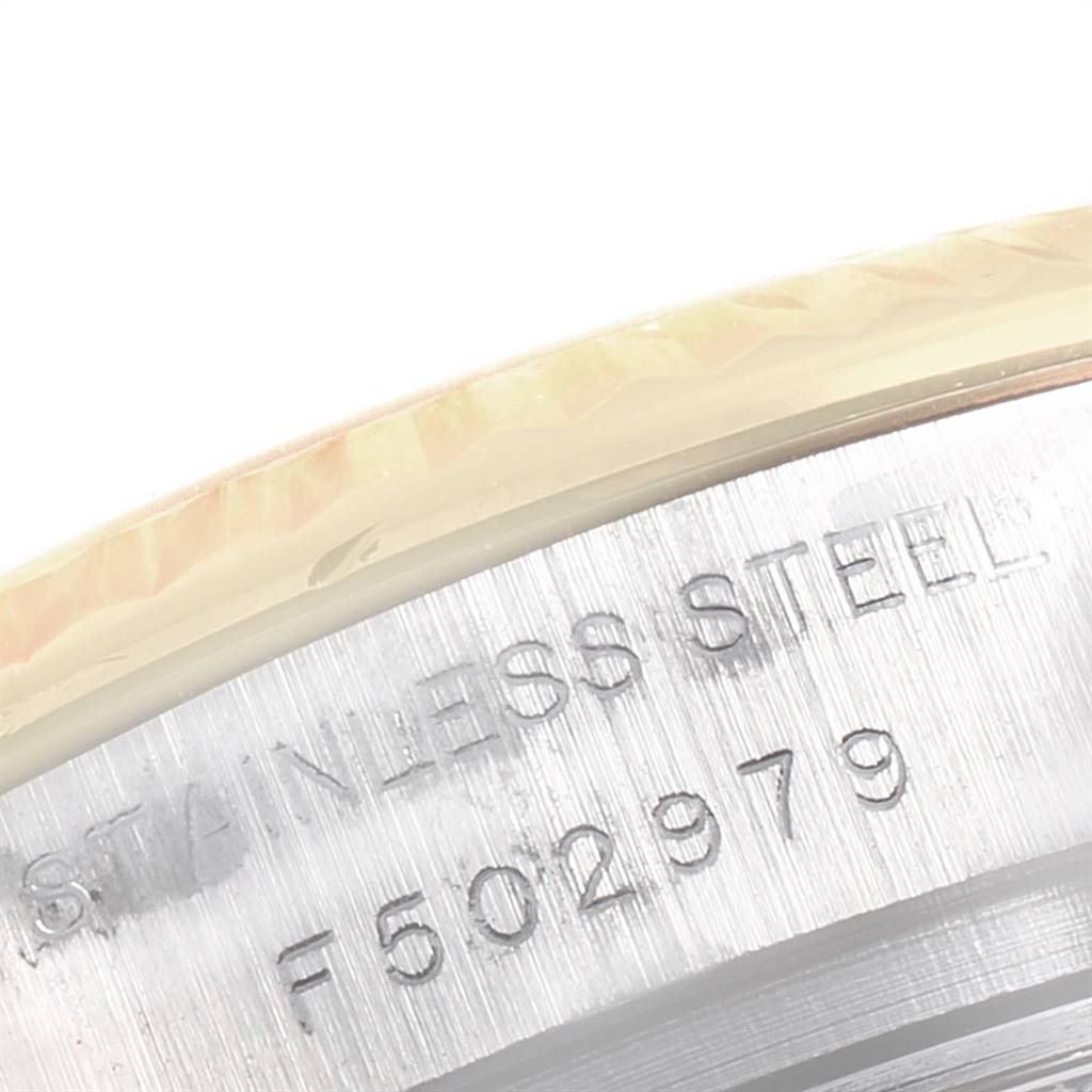 This close-up image shows the serial number and "STAINLESS STEEL" engraving on the case of a Rolex Datejust 179173 Women's Steel and Gold (two tone) Silver Dial 179173 Women's Steel and Gold (two tone) Silver Dial watch.