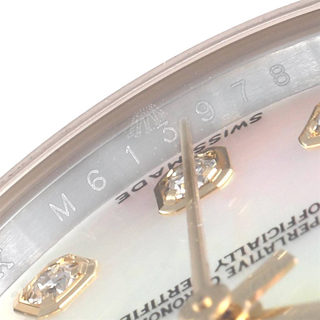 This close-up image of the Rolex Datejust 179173 Women's Steel and Gold (two tone) Mother of Pearl Dial 179173 Women's Steel and Gold (two tone) Mother of Pearl Dial watch shows the dial with diamond hour markers and part of the serial number engraving.