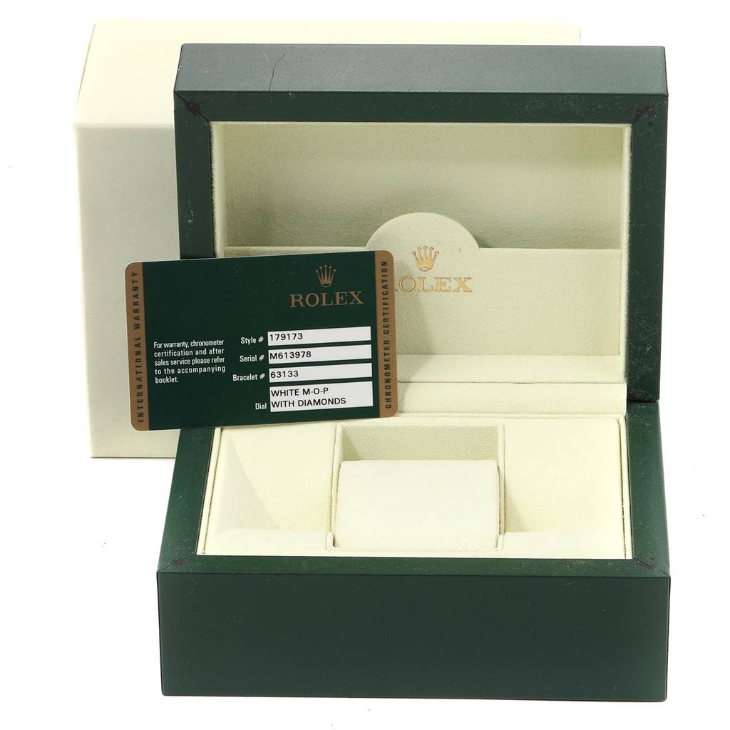 This image shows an open Rolex Datejust 179173 Women's Steel and Gold (two tone) Mother of Pearl Dial 179173 Women's Steel and Gold (two tone) Mother of Pearl Dial box with an international warranty card visible, angled from the front.