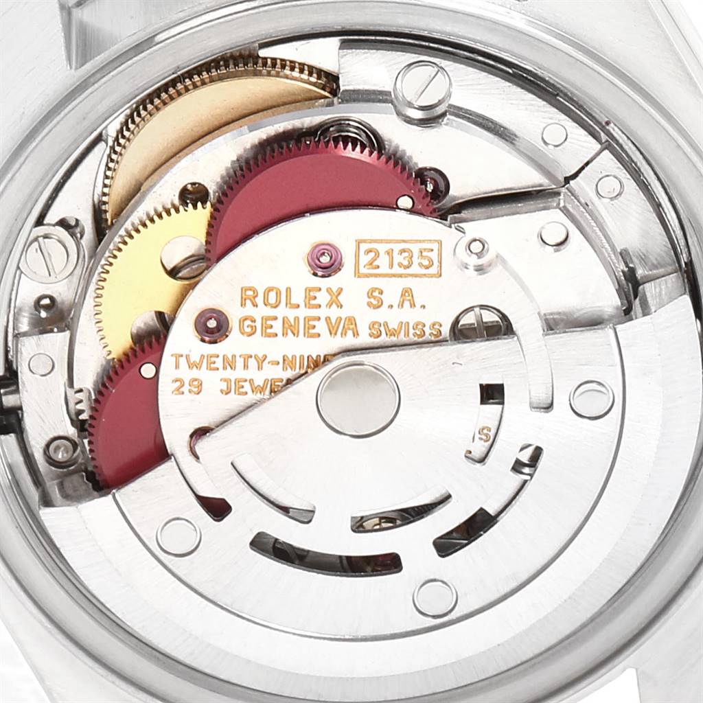 The image shows the internal mechanism of a Rolex Datejust 69174 Women's Stainless Steel Pink Dial 69174 Women's Stainless Steel Pink Dial, focusing on its gears and movement components.