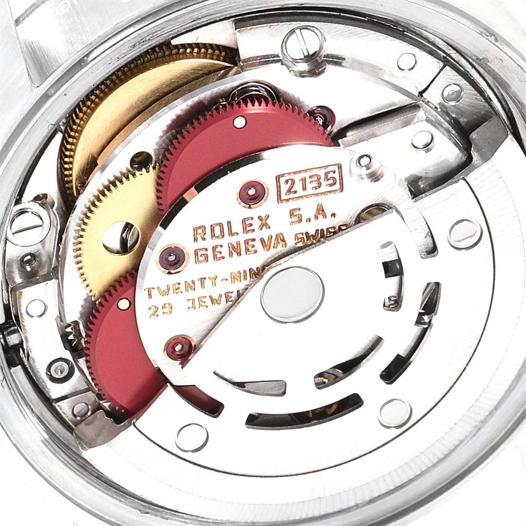 The image shows a close-up view of the movement mechanism of a Rolex Datejust 69174 Women's Stainless Steel Blue Dial 69174 Women's Stainless Steel Blue Dial watch, highlighting its intricate gears and components.