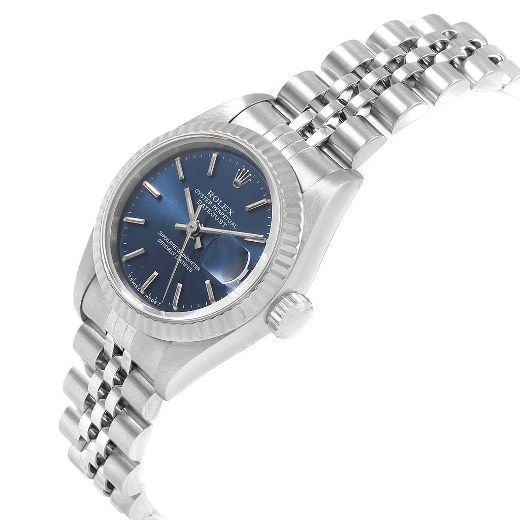 The image shows a side angle of a Rolex Datejust 69174 Women's Stainless Steel Blue Dial 69174 Women's Stainless Steel Blue Dial watch highlighting the blue dial, fluted bezel, and Jubilee bracelet.