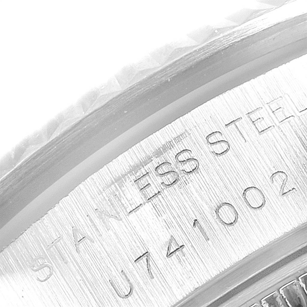 This image shows a close-up of the case back and serial number of a Rolex Datejust 69174 Women's Stainless Steel Grey Dial 69174 Women's Stainless Steel Grey Dial watch, highlighting "Stainless Steel."