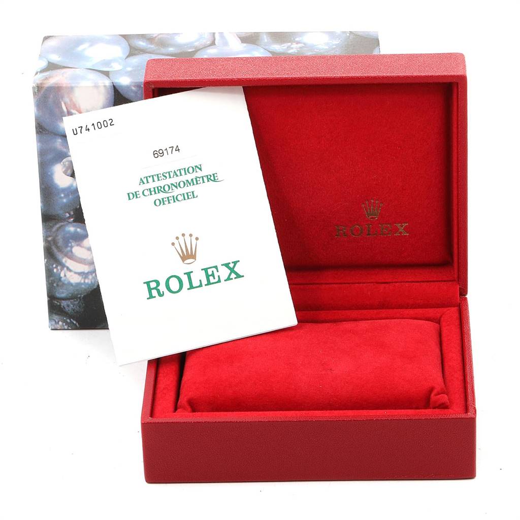 The image shows an open red Rolex Datejust 69174 Women's Stainless Steel Grey Dial 69174 Women's Stainless Steel Grey Dial box with a certificate booklet inside.