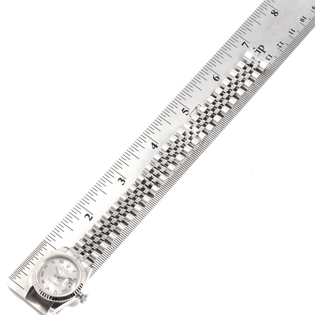 The image shows a Rolex Datejust 179174 Women
s Stainless Steel Grey Dial 179174 Women
s Stainless Steel Grey Dial watch lying flat next to a ruler with the face and bracelet visible.