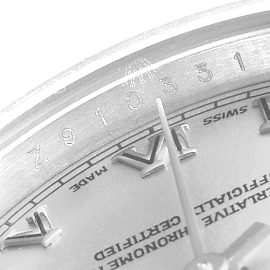 The image shows a close-up of the Rolex Datejust 179174 Women
s Stainless Steel Grey Dial 179174 Women
s Stainless Steel Grey Dial watch, focusing on the top part of the dial and a portion of the serial number.