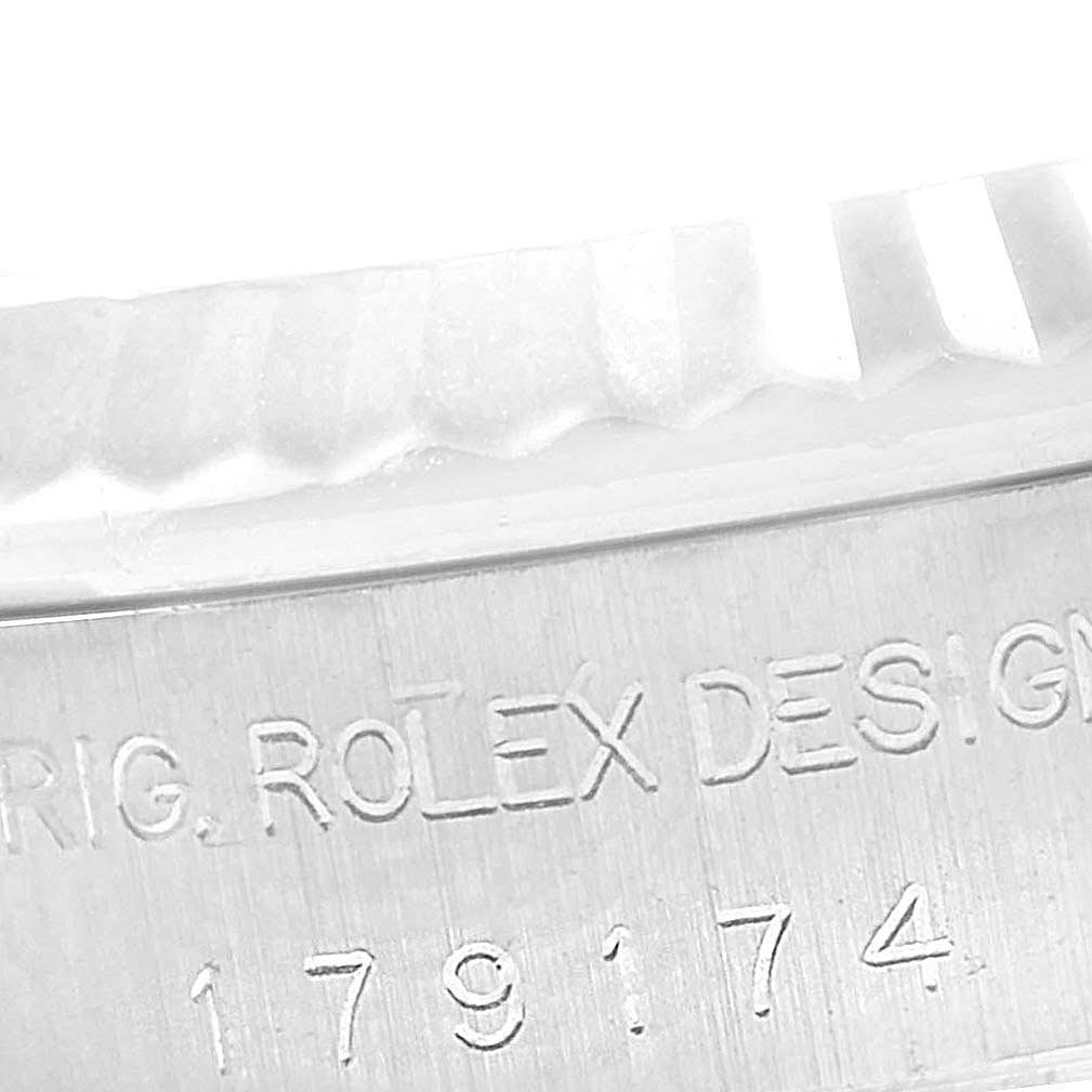 The image shows a close-up of the model number engraved on the side of a Rolex Datejust 179174 Women
s Stainless Steel Grey Dial 179174 Women
s Stainless Steel Grey Dial watch case, near the fluted bezel.