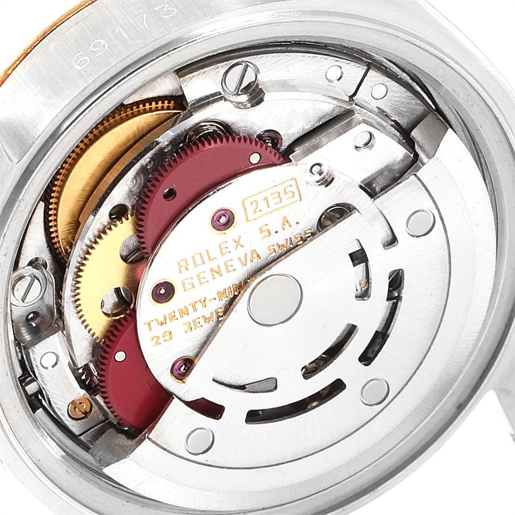 The image shows the internal mechanism of a Rolex Datejust 69173 Women's Stainless Steel Champagne Dial 69173 Women's Stainless Steel Champagne Dial watch, highlighting its gears and movement parts.