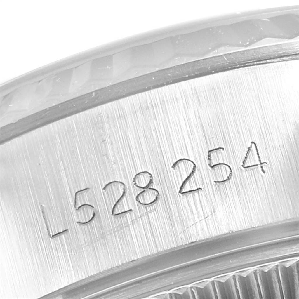 This close-up image shows the serial number engraving on the side of the case of a Rolex Datejust 69174 Women's Stainless Steel Blue Dial 69174 Women's Stainless Steel Blue Dial watch.