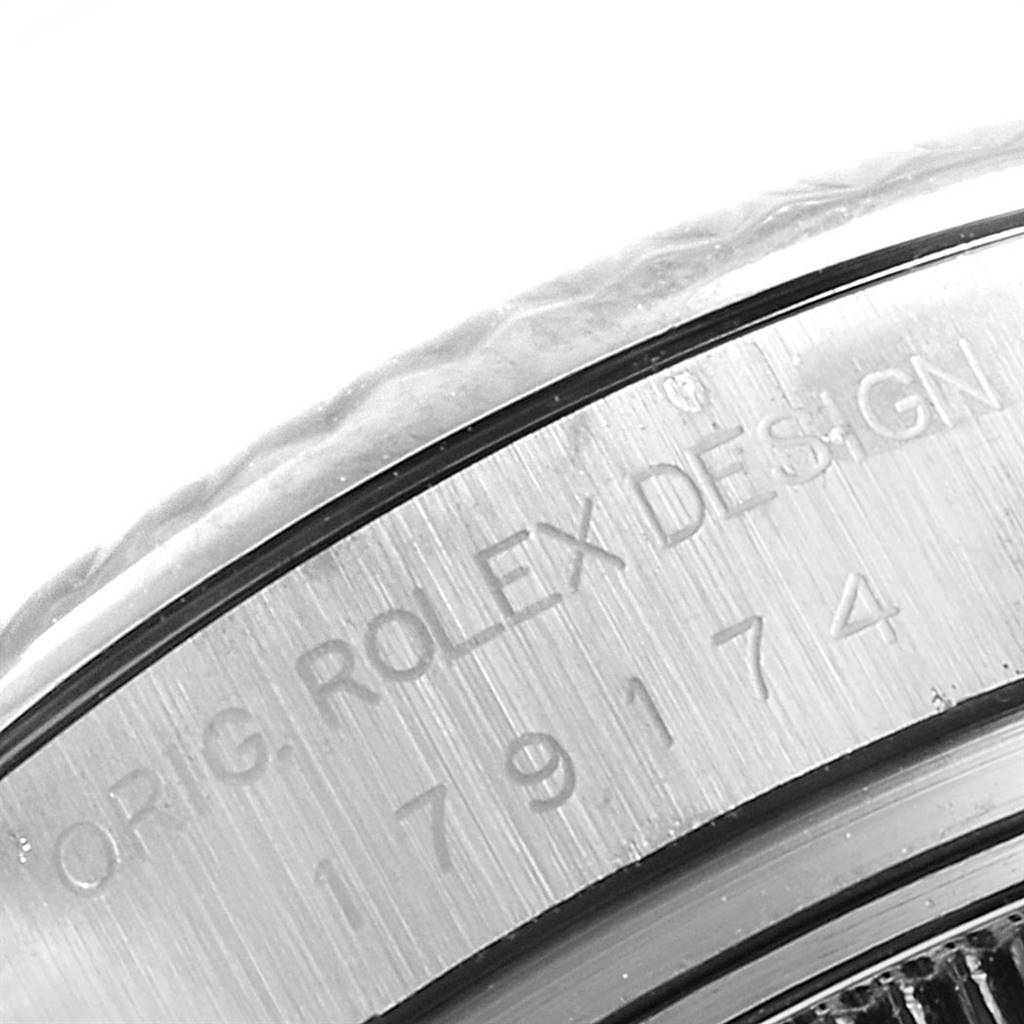 The image shows a close-up of the engraved bezel of a Rolex Datejust 179174 Women's Stainless Steel White Dial 179174 Women's Stainless Steel White Dial watch.