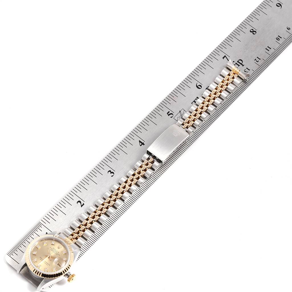 The Rolex Datejust 69173 Women's Stainless Steel Beige Dial 69173 Women's Stainless Steel Beige Dial watch is shown from a top-down angle, featuring its face and bracelet, measured with a ruler.