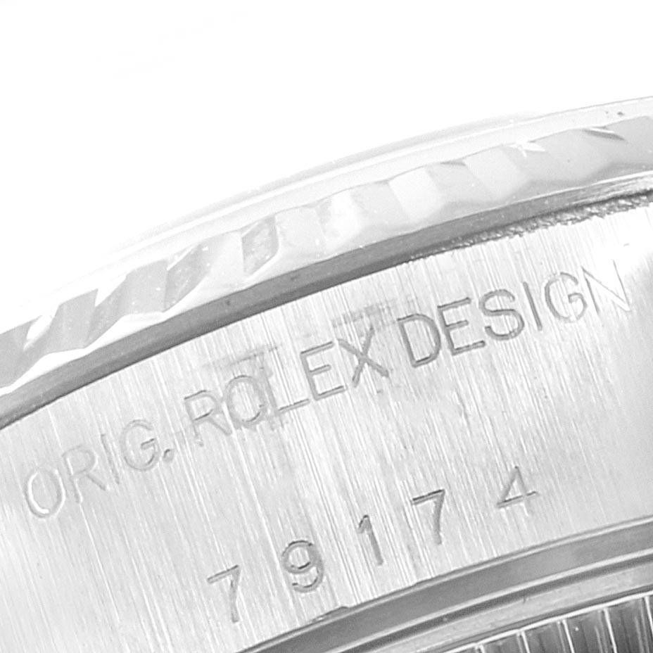 This close-up image shows the engraved text and part of the bezel of a Rolex Datejust 79174 Women's Stainless Steel Blue Dial 79174 Women's Stainless Steel Blue Dial watch.