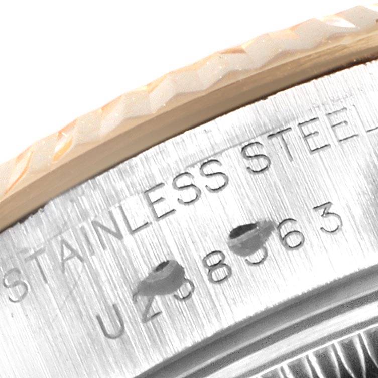 This image shows a close-up of the stainless steel bezel, case, and serial number engraving on a Rolex Datejust 69173 Women's Stainless Steel Silver Dial 69173 Women's Stainless Steel Silver Dial watch.