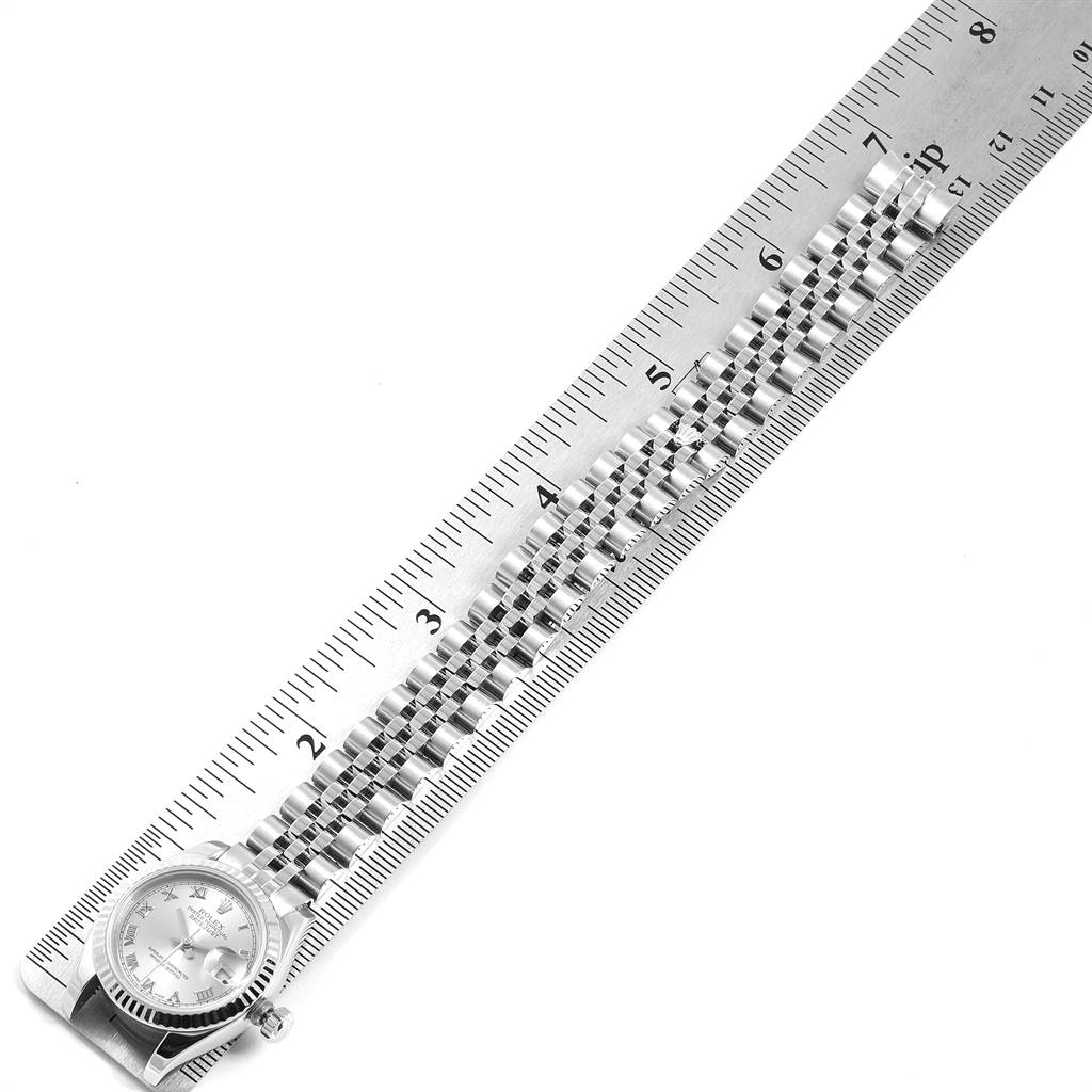 The Rolex Datejust 179174 Women's Stainless Steel Grey Dial 179174 Women's Stainless Steel Grey Dial watch is shown with its bracelet, alongside a ruler for scale.