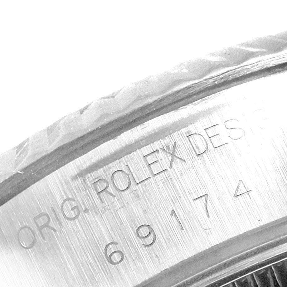 The image shows a close-up view of the engravings on the case side of a Rolex Datejust 69174 Women's Stainless Steel White Dial 69174 Women's Stainless Steel White Dial watch.