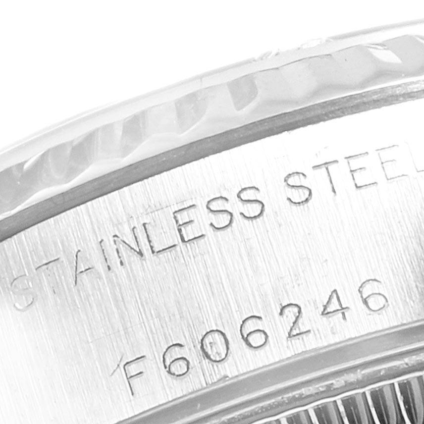 This close-up image of the Rolex Datejust 79174 Women's Stainless Steel Grey Dial 79174 Women's Stainless Steel Grey Dial shows the side case with "STAINLESS STEEL" and a serial number engraved.