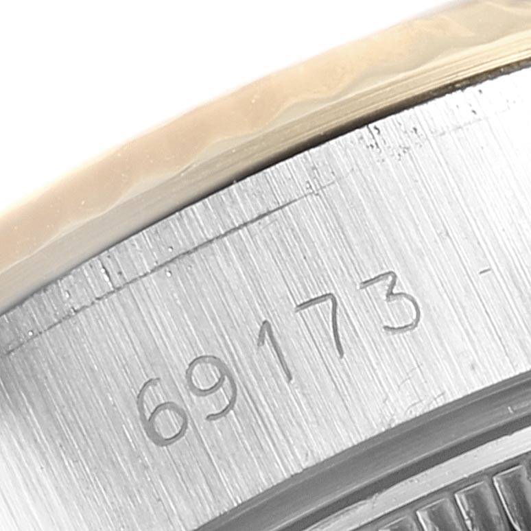This close-up image shows the serial number engraving on the case of a Rolex Datejust 69173 Women's Stainless Steel Champagne Dial 69173 Women's Stainless Steel Champagne Dial watch.