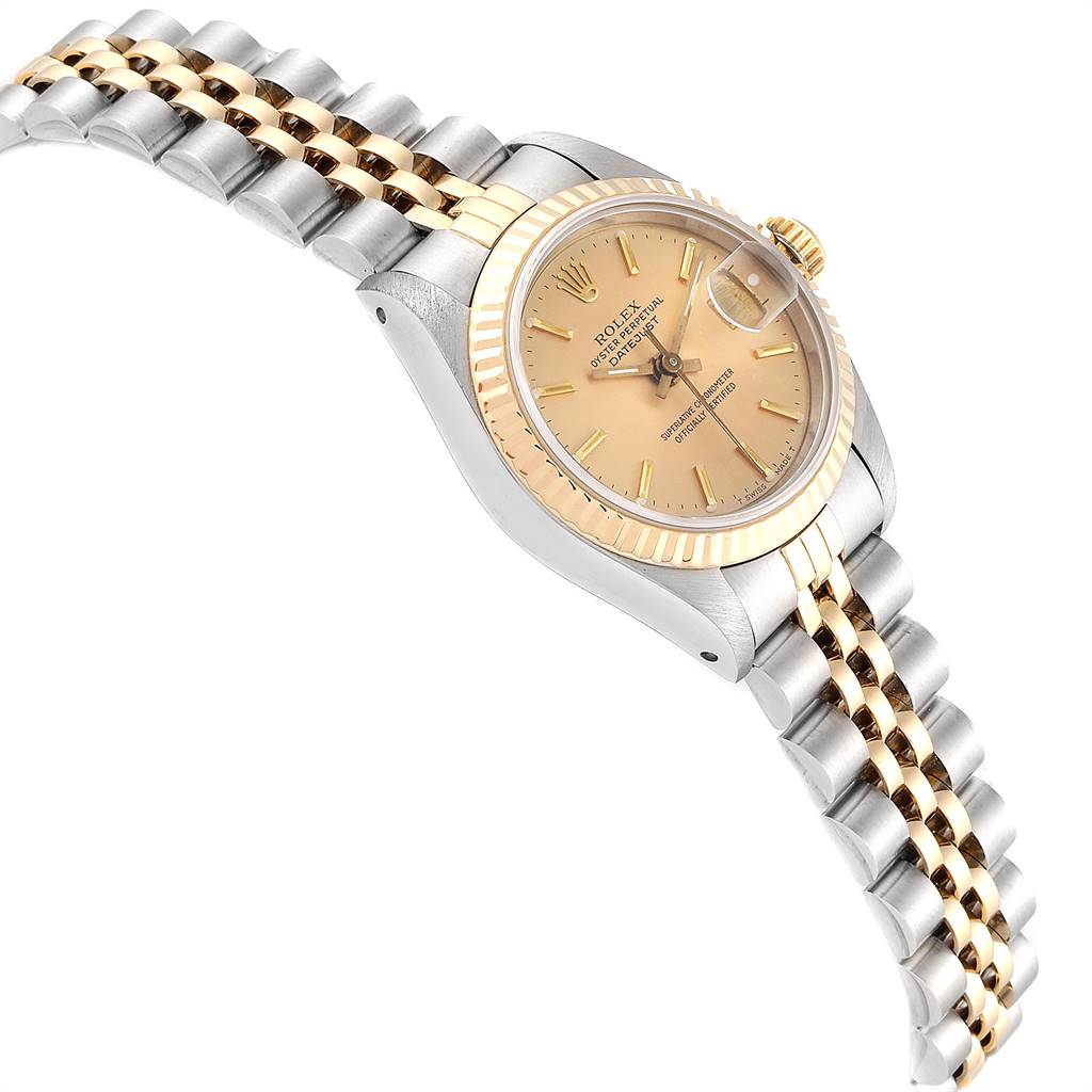 This image shows a side angle of a Rolex Datejust 69173 Women's Stainless Steel Champagne Dial 69173 Women's Stainless Steel Champagne Dial watch, displaying its two-tone bracelet, gold bezel, and champagne dial.