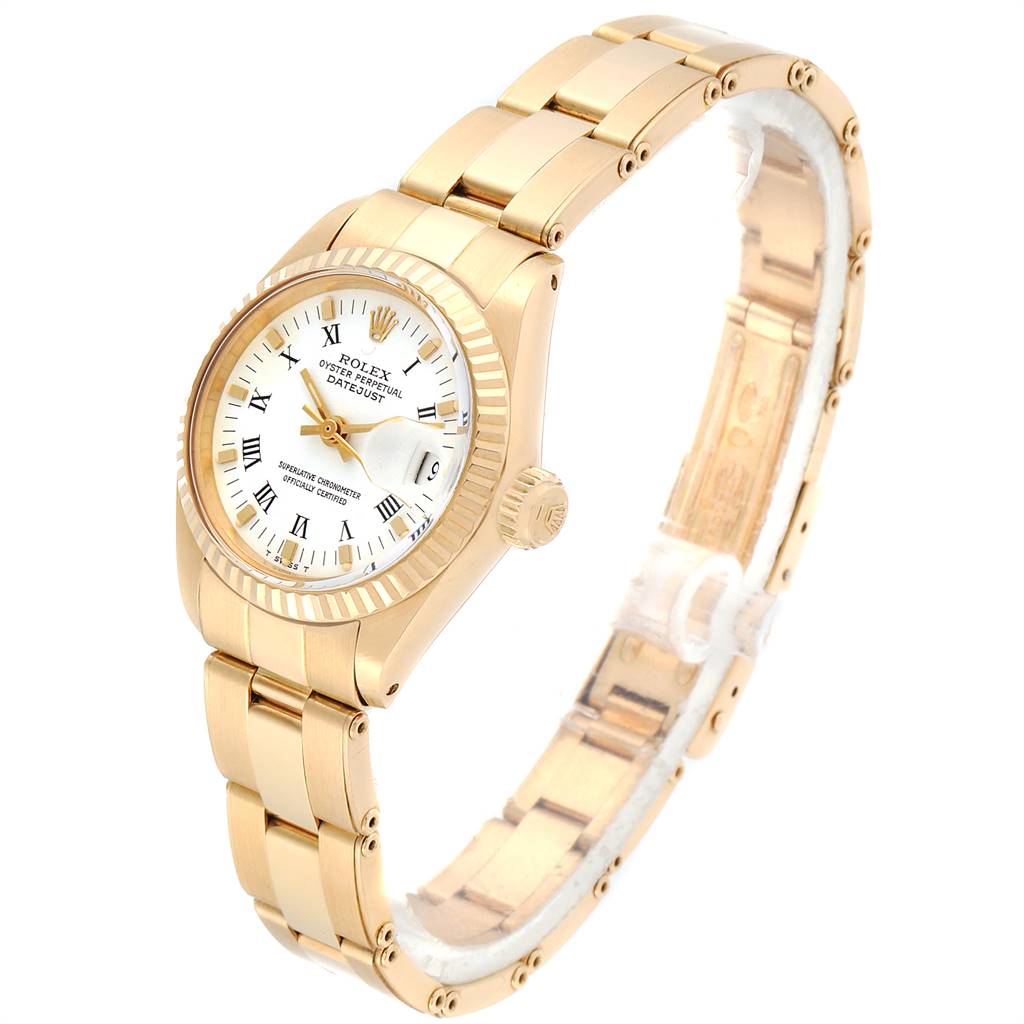 The image shows a Rolex Datejust 6917 Women
s Yellow Gold White Dial 6917 Women
s Yellow Gold White Dial watch at an angle displaying the dial, bezel, crown, and bracelet.