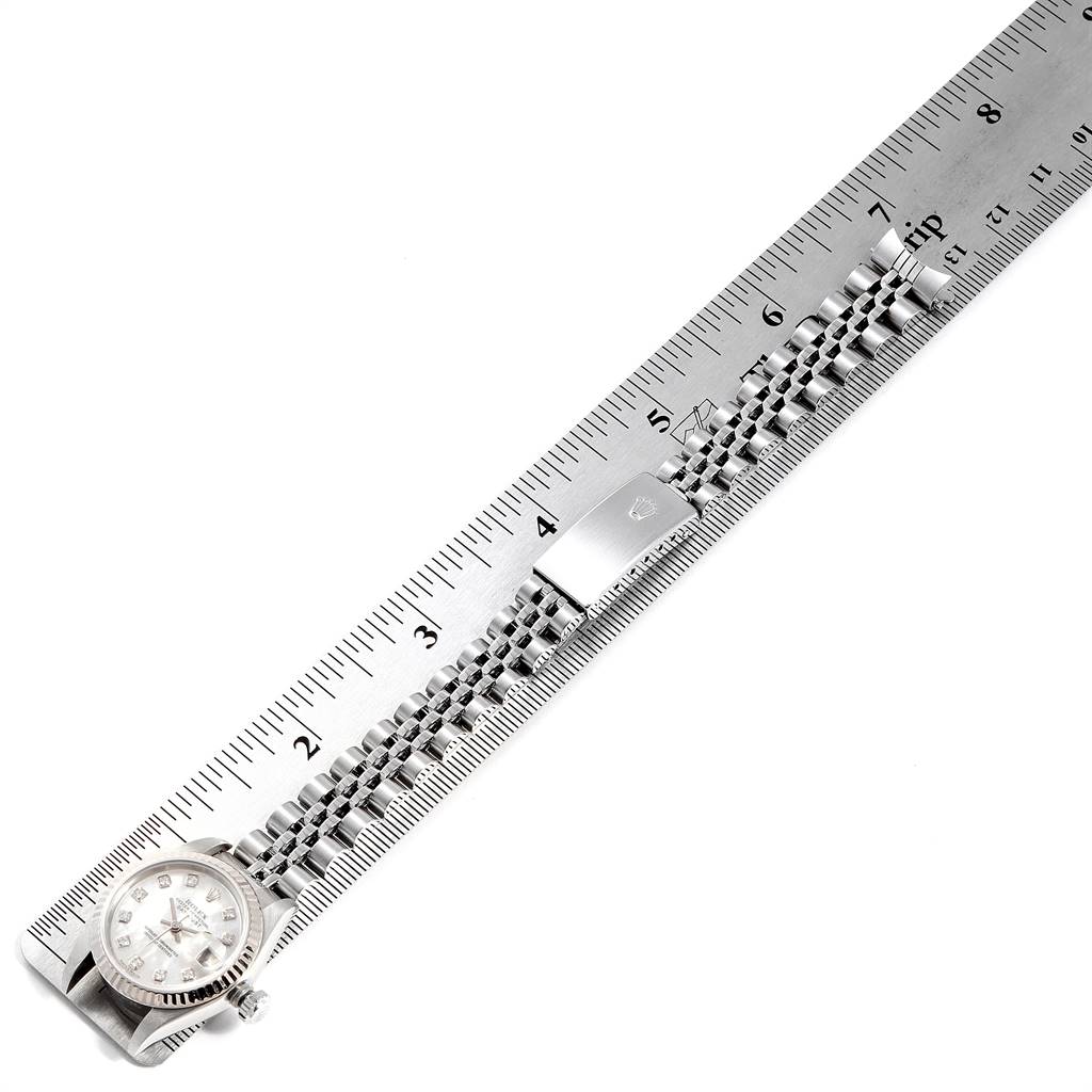 The image shows a Rolex Datejust 79174 Women's Stainless Steel Mother of Pearl Dial 79174 Women's Stainless Steel Mother of Pearl Dial watch laid flat with its bracelet stretched alongside a ruler for measurement.
