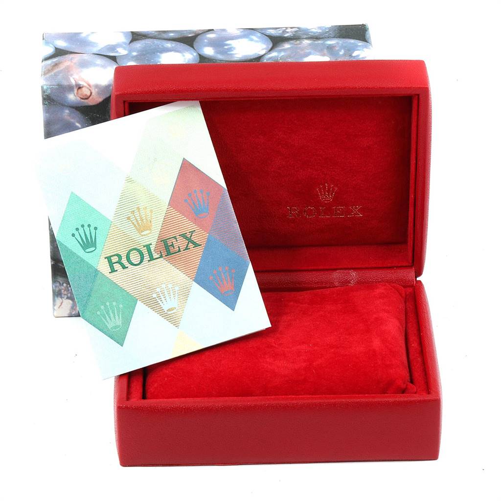 This image shows the open box and a booklet for a Rolex Datejust 79174 Women's Stainless Steel Mother of Pearl Dial 79174 Women's Stainless Steel Mother of Pearl Dial watch.