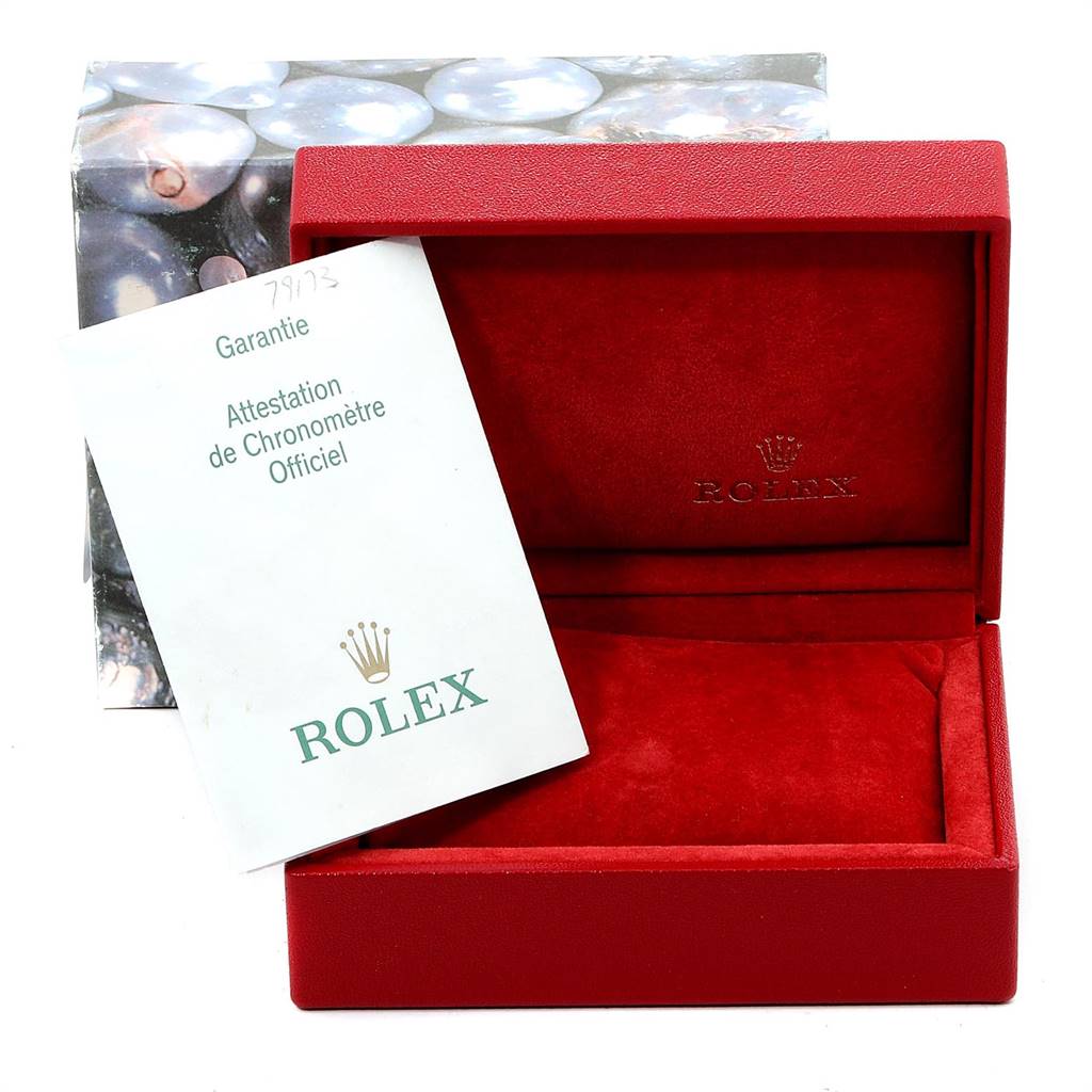 The image shows a Rolex Datejust 79173 Women's Stainless Steel White Dial 79173 Women's Stainless Steel White Dial watch's red box and warranty card angled towards the viewer.