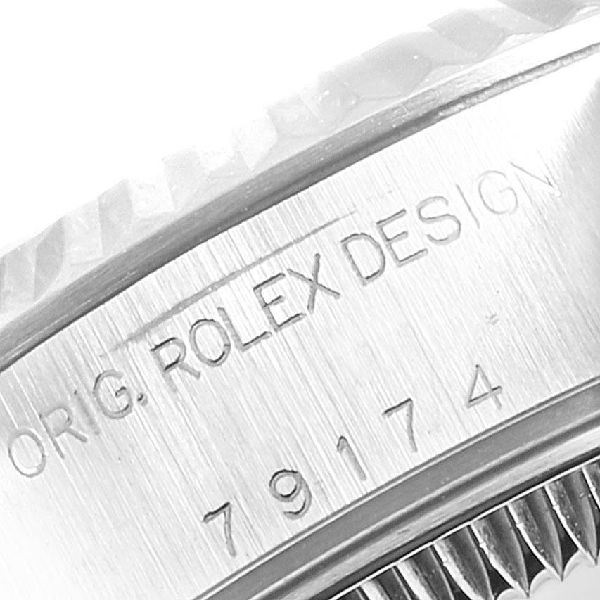 This close-up view shows the engraved caseback edge of a Rolex Datejust 79174 Women's Stainless Steel Silver Dial 79174 Women's Stainless Steel Silver Dial watch.
