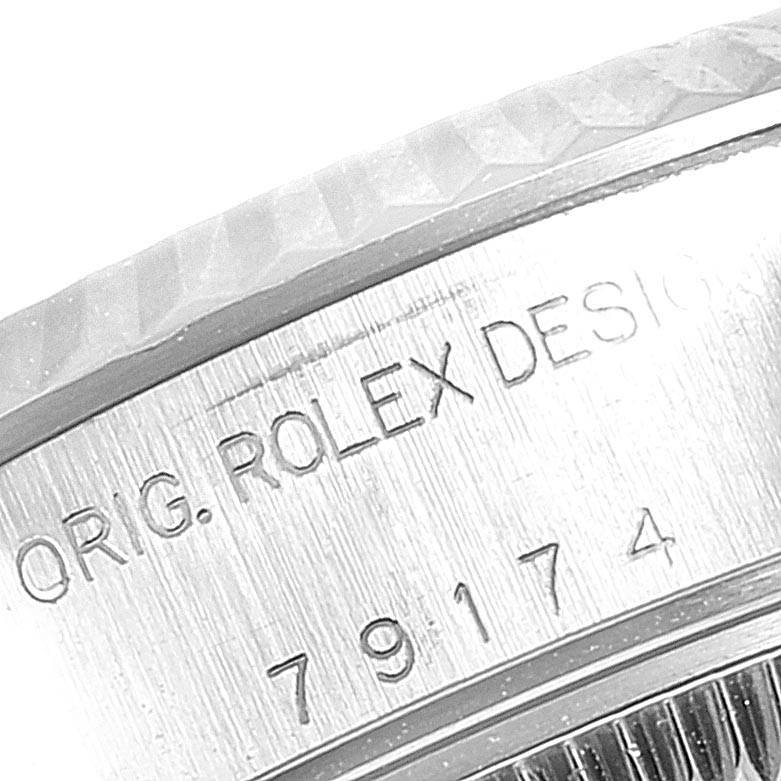 This close-up image of the Rolex Datejust 79174 Women's Stainless Steel Grey Dial 79174 Women's Stainless Steel Grey Dial watch shows the engraved design details and partially visible fluted bezel.