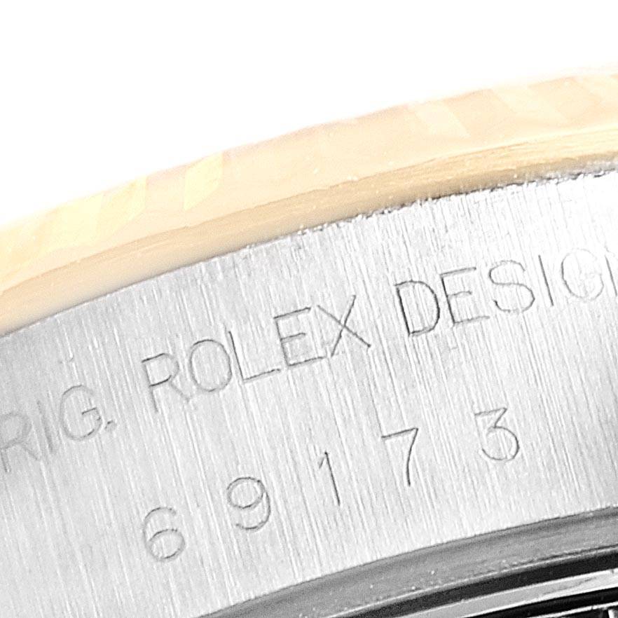This close-up image shows the engraved model number and part of the bezel of the Rolex Datejust 69173 Women's Stainless Steel Black Dial 69173 Women's Stainless Steel Black Dial watch.